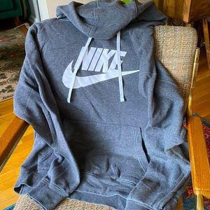 Dark grey Nike hood with white Nike letter and white hoodie strings .